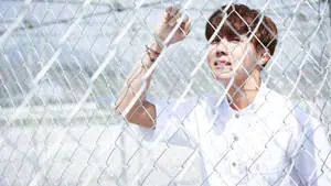 J-Hope Holding On A Fence