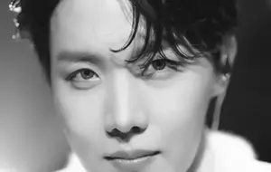 Jhope from BTS striking a cool pose at a photoshoot.